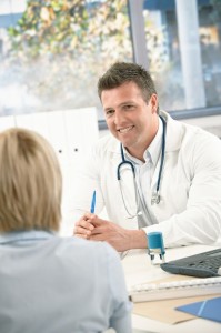 7653597 - smiling medical doctor consulting patient in bright office.