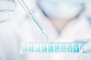 Close up a scientist working in laboratory to analyze blue extra